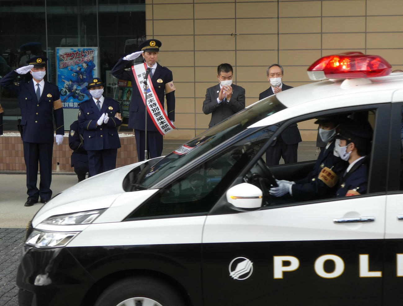 滋賀県警の歳末特別警戒本部長に就任した武豊騎手は、敬礼でパトカーの出動を見守る（撮影・太田尚樹）
